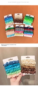 Detail shot of assorted satin scrunchies set on display cards for stylish hair styling
