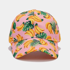 Close-up of pink baseball cap featuring tropical banana print and palm leaf pattern