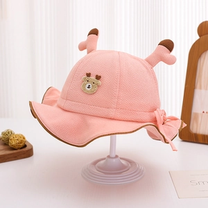 Detail of pink baby bucket hat featuring 3D antlers, bear patch and wavy brim design