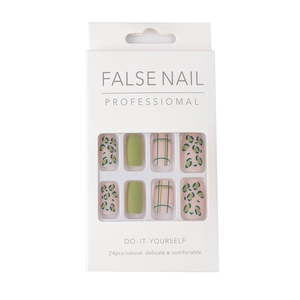 Long square matte press-on nails featuring green leopard and plaid patterns in a box