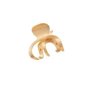 Elegant gold metal hair claw clip with textured surface design on white background