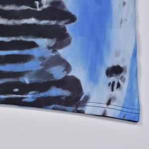 Close-up of the double-needle stitched hem on a blue and black abstract printed dress