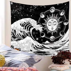Psychedelic tarot tapestry with sun, moon, and ocean waves hanging on a bedroom wall