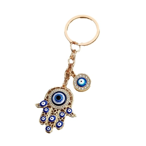 Golden Hamsa hand keychain with blue evil eye beads and sparkling rhinestones