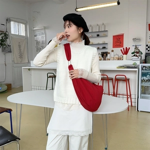 Minimalist red canvas dumpling crossbody bag styled with autumn knit outfit