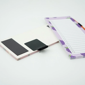 Macro shot of purple grape magnetic notepad showing the back magnet and elastic pen loop