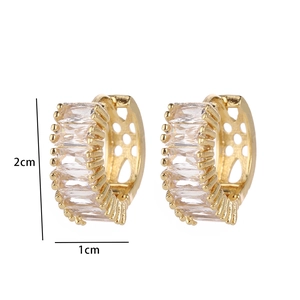 Detail view of gold earrings featuring rectangular zircon inlay and 2cm size mark