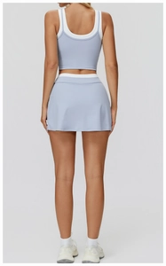 Back view of light blue sports set featuring a crop top and matching mini skirt