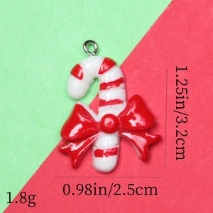 Detail of candy cane resin pendant with red bow, measuring 3.2cm in height and 2.5cm in width