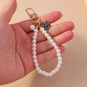 Elegant beaded pearl keychain with black floral charm and gold lobster clasp