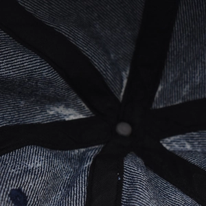 Macro shot of internal six-panel stitching and reinforced seams of a denim baseball cap