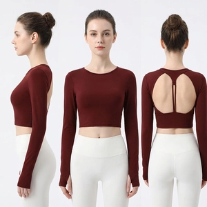 Slim fit burgundy yoga top featuring a back cutout and functional thumbholes for support