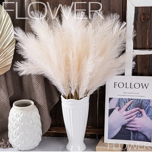 Detail of fluffy ivory artificial pampas grass in a white ceramic vase for home decor