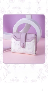 Detail of floral wallet featuring lavender flower patterns and wristlet strap closure