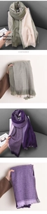 Detailed view of bicolor plaid imitation cashmere scarf with tassels and soft texture