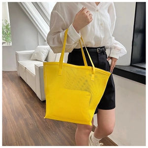 Macro view of bright yellow mesh tote bag showing breathable material and sewing detail