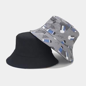 Detail of reversible cotton bucket hat featuring cute school themed pencil patterns