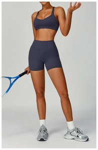 Detail of high-waist recycled sports shorts and matching bra with matte finish