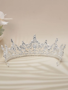 Detailed close-up of a vintage silver bridal crown with intricate rhinestone floral patterns