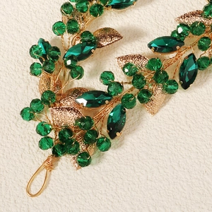 Detail showing green beads and golden metal leaves on a double-layer handmade bridal headband