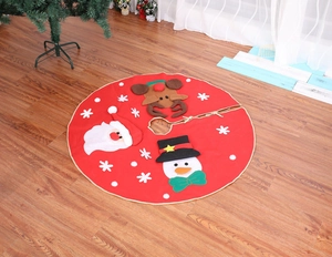 Detail of red Christmas tree skirt with embroidered Santa and reindeer patterns