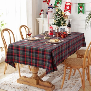 Festive red and green plaid cotton polyester tablecloth set on a wooden dining table