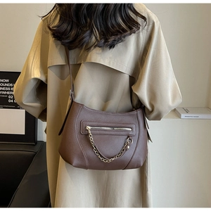 Brown litchi grain PU leather crossbody bag with gold chain zipper detail and adjustable strap