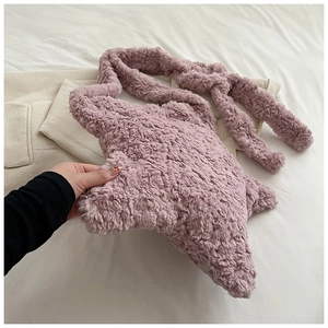 Detailed view of soft plush star-shaped handbag in dusty pink with furry shoulder strap