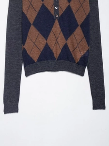 Detail of the diamond knit texture and buttoned collar on the vintage polo shirt