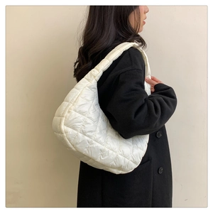 Side view of white quilted puffer shoulder bag with minimalist rhombic stitching pattern