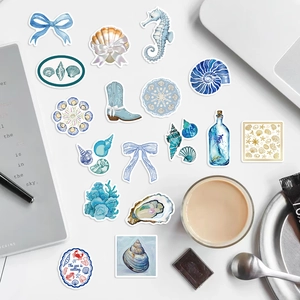 Detailed flatlay of blue ocean-themed aesthetic stickers with sea creatures and seashells