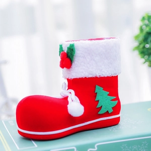 Macro view of Christmas candy boot with red flocking texture and white faux fur trim
