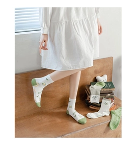 Detail of white cotton mid-calf socks with green avocado print and comfortable knit
