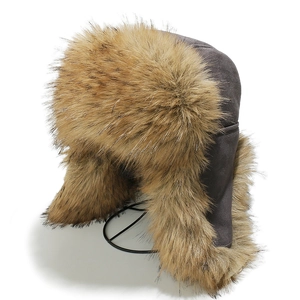 Detail of dark grey faux suede trapper hat with thick brown faux fur lining and earflaps
