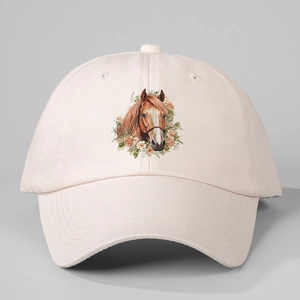Detailed view of horse and floral embroidery on a light pink adjustable cotton baseball cap