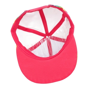 Detail view of red shiny patent leather baseball cap internal lining and plastic strap