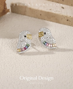 Detail of S925 silver parrot earrings with pavé white zircons and rainbow gemstones
