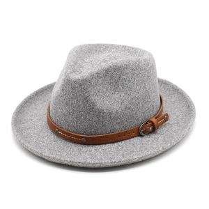 Close-up of classic grey wool fedora hat featuring a brown leather band and metal buckle