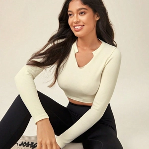 Slim fit cream ribbed long sleeve yoga top with V-neck cutout for women's fitness