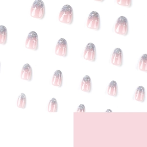 Pink gradient press-on nails with silver glitter French tips and white star patterns