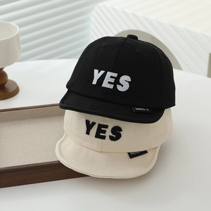 Cotton baby baseball caps in black and cream with YES embroidery and short brims
