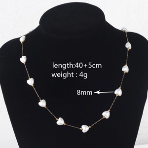 Detail view of heart pearl necklace on mannequin showing 40+5cm length and 8mm bead size