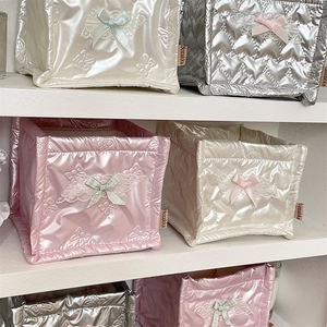 Close-up of quilted PU leather storage baskets with lace bows in silver and pink