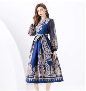 Detailed view of long sleeve paisley print dress with sheer lantern sleeves and waist tie
