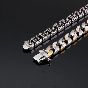 Close-up of gold and silver Cuban link bracelets with pave-set zircon and industrial hollow links