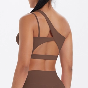 Detail of coffee brown one-shoulder sports bra with criss-cross cutout back straps
