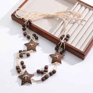 Close-up of Bohemian waist chain with multi-layer wooden beads and star pendants