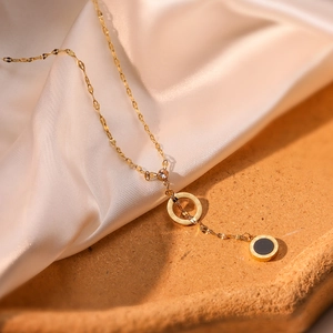 Elegant gold titanium necklace with Roman numerals pendant and black circular detail
