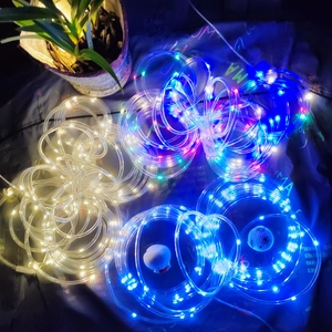 Detail of flexible solar LED rope lights in warm white, blue and RGB colors for garden