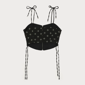 Detail of black cotton camisole featuring silver cross embroidery and front metal zipper